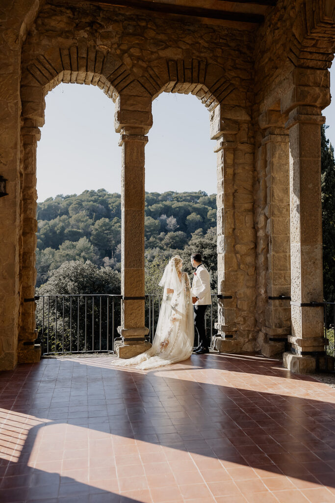 Bride and groom standing together on the panoramic terrace during their La Baronia wedding in Barcelona Spain.
