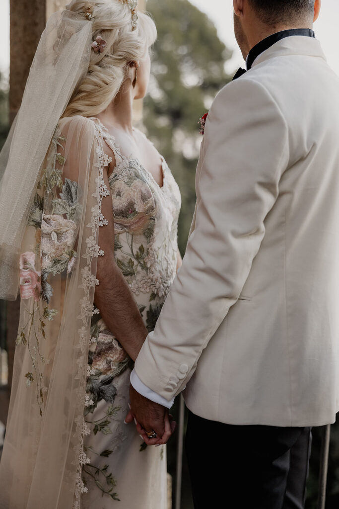 Close up of bride and groom holding hands during portraits at La Baronia wedding venue in Barcelona Spain