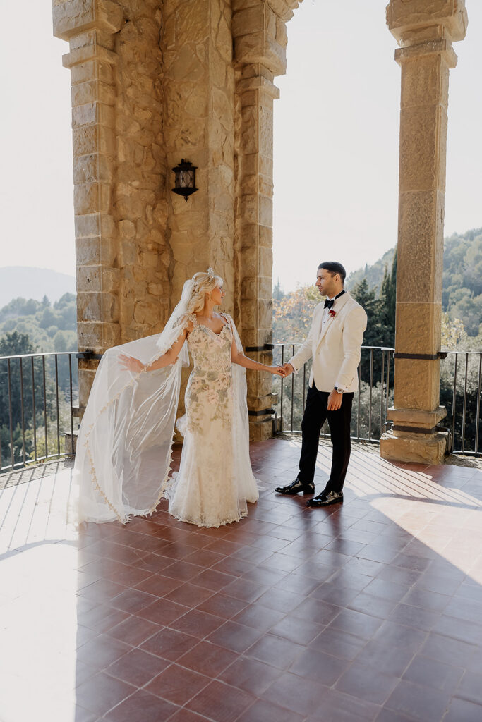 Bride and groom holding hands on the panoramic terrace during their La Baronia wedding in Barcelona Spain.