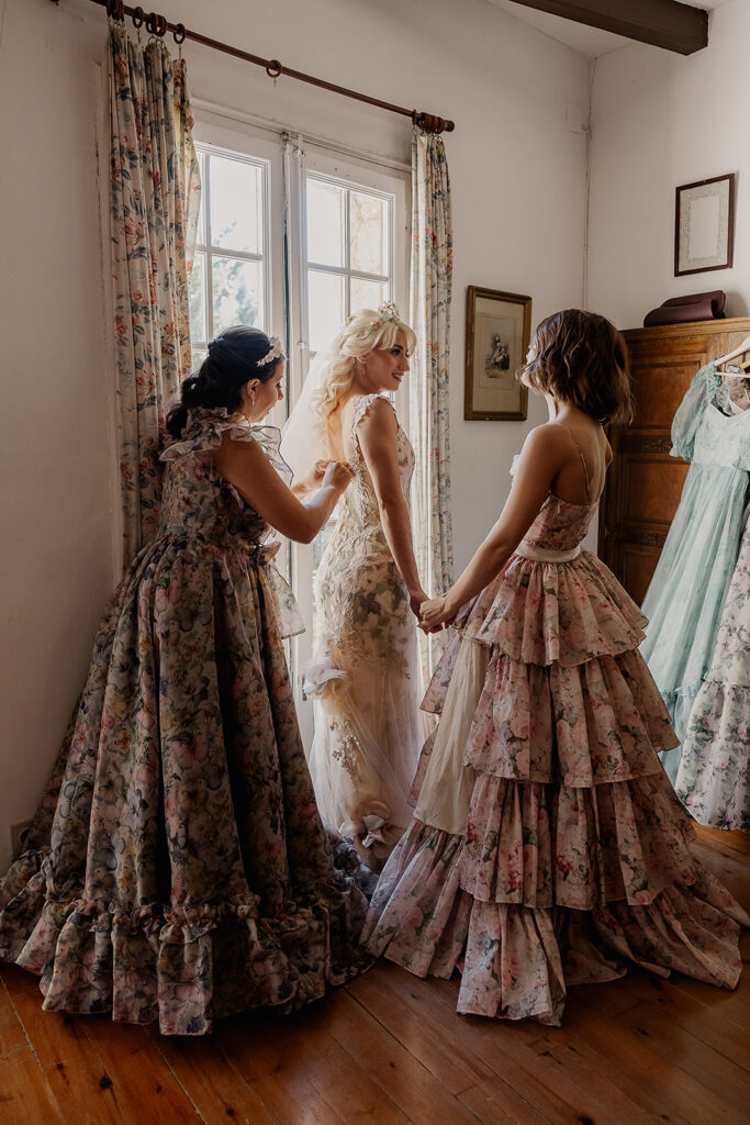 Bride getting ready with bridesmaids in floral dresses during a La Baronia wedding morning in Barcelona Spain.