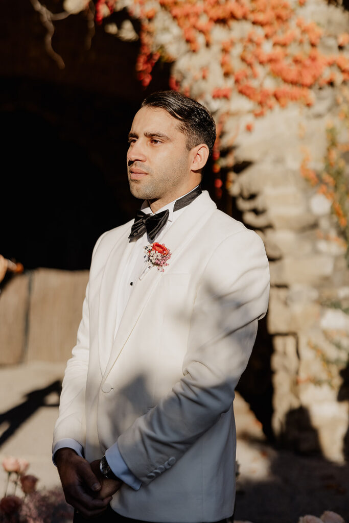 Groom waiting during outdoor ceremony at the Cabañon at La Baronia wedding venue in Barcelona Spain.