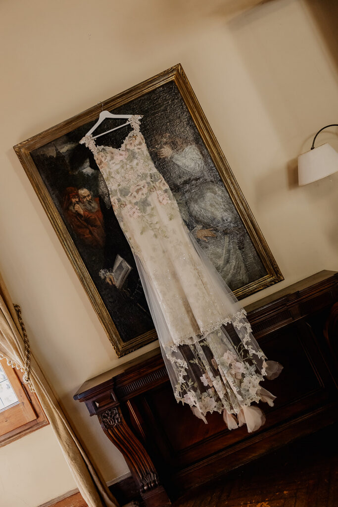 Bride’s embroidered Claire Pettibone wedding dress hanging inside La Baronia before a Barcelona Spain wedding.