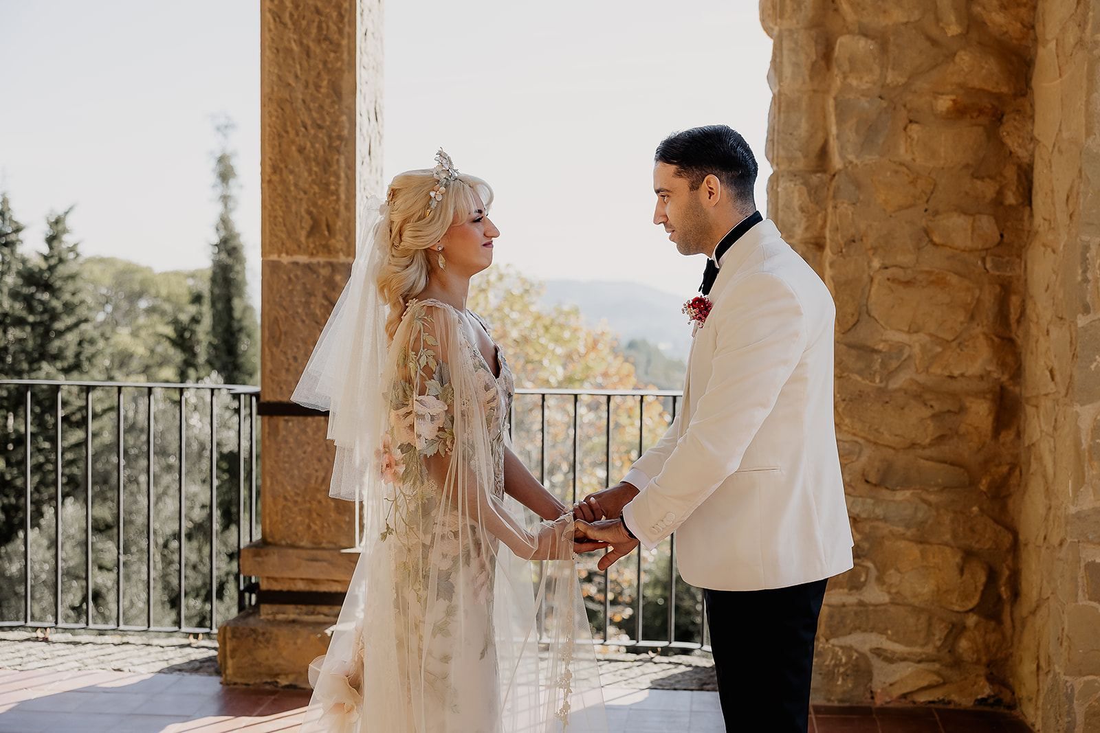 Bride and groom holding hands during their first look at their La Baronia wedding in Barcelona Spain.