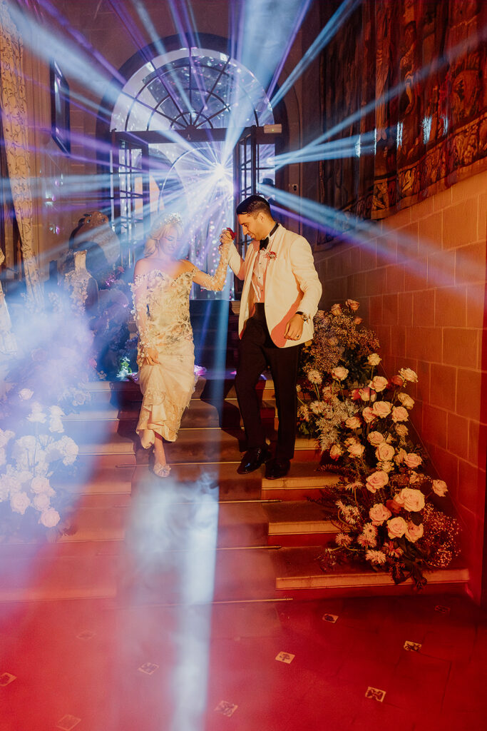 Bride and groom entering reception through fog and dramatic lighting at La Baronia wedding venue in Barcelona Spain