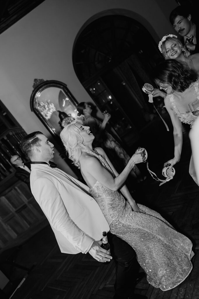 Black and white photo of a bride and groom dancing during the reception. 