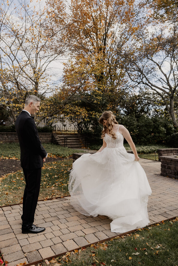 Bride twirling for the groom as they share a first look at The Farmhouse wedding venue in Hampton, NJ.