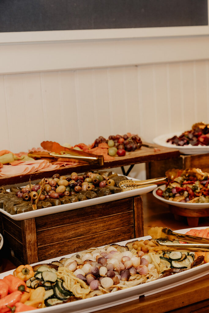 Cocktail hour food display with vegetables and olives at The Farmhouse wedding venue in Hampton, NJ.