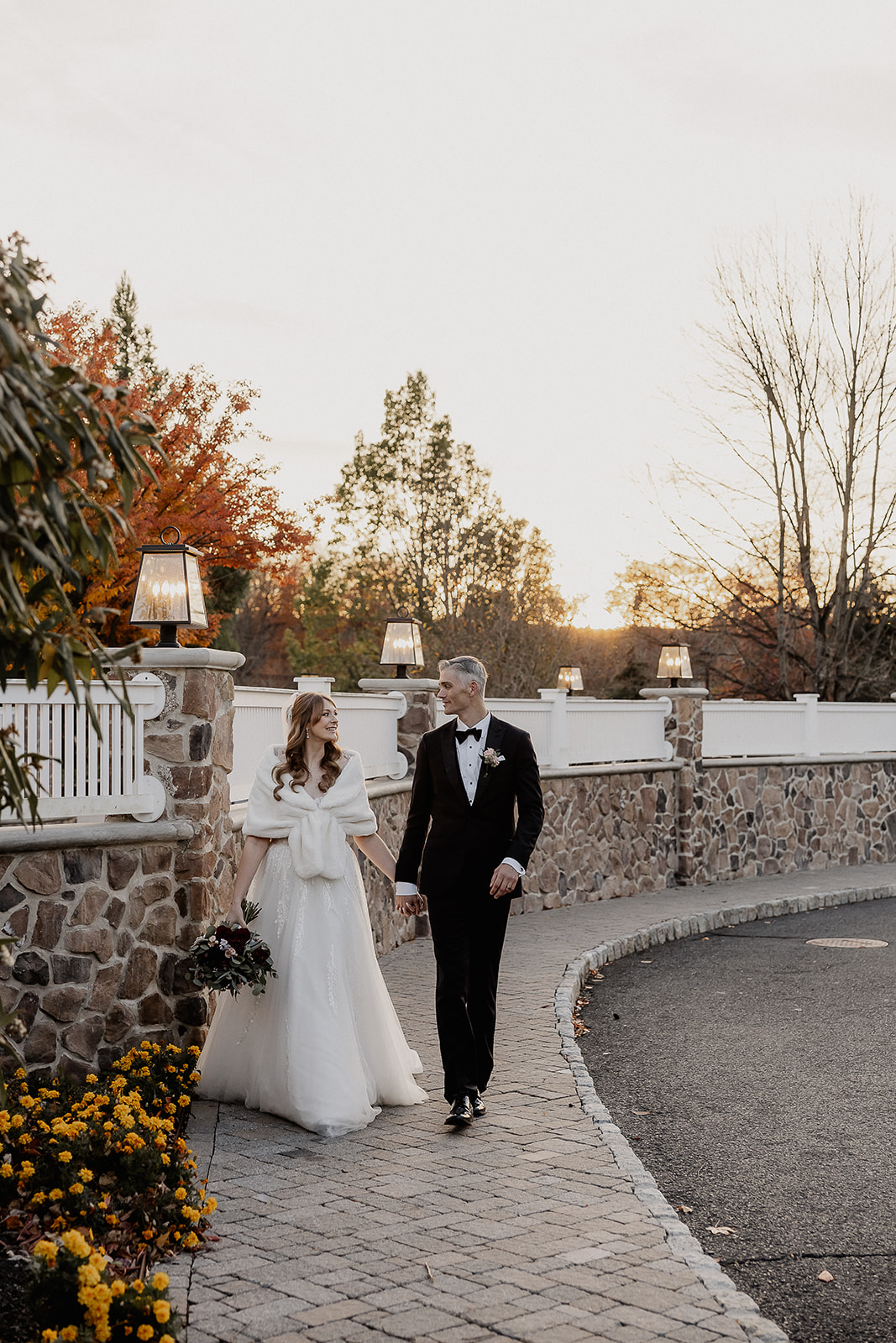 Bride and groom walking the pathways at The Farmhouse wedding venue in Hampton, NJ.