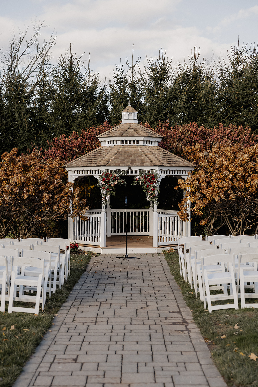 Gazebo ceremony setup with white chairs at The Farmhouse wedding venue in Hampton, NJ.