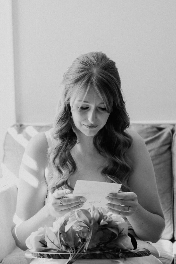 Bride reading a note during getting ready at a farmhouse wedding in Hampton, NJ.