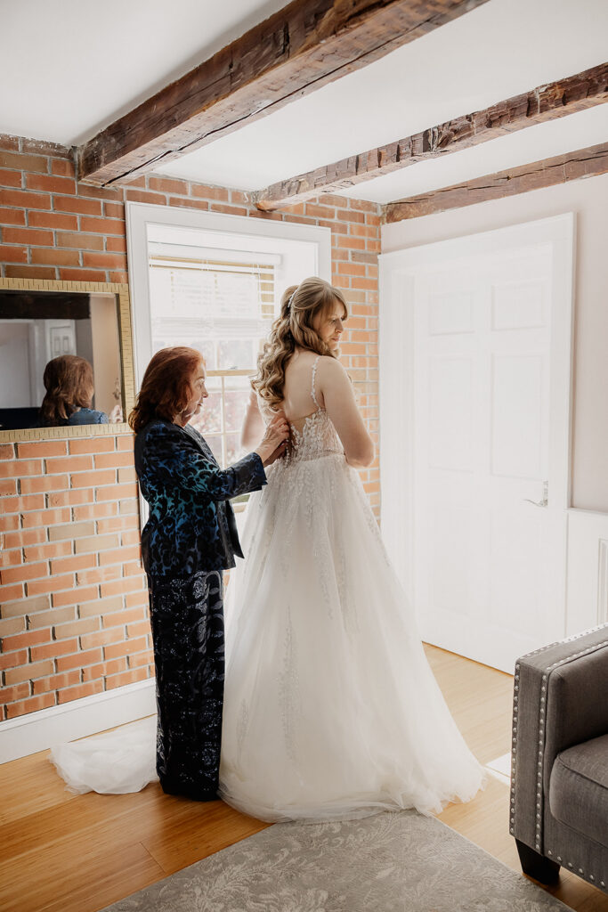 Bride getting dressed with her grandmother during getting ready at a farmhouse wedding in Hampton, NJ.