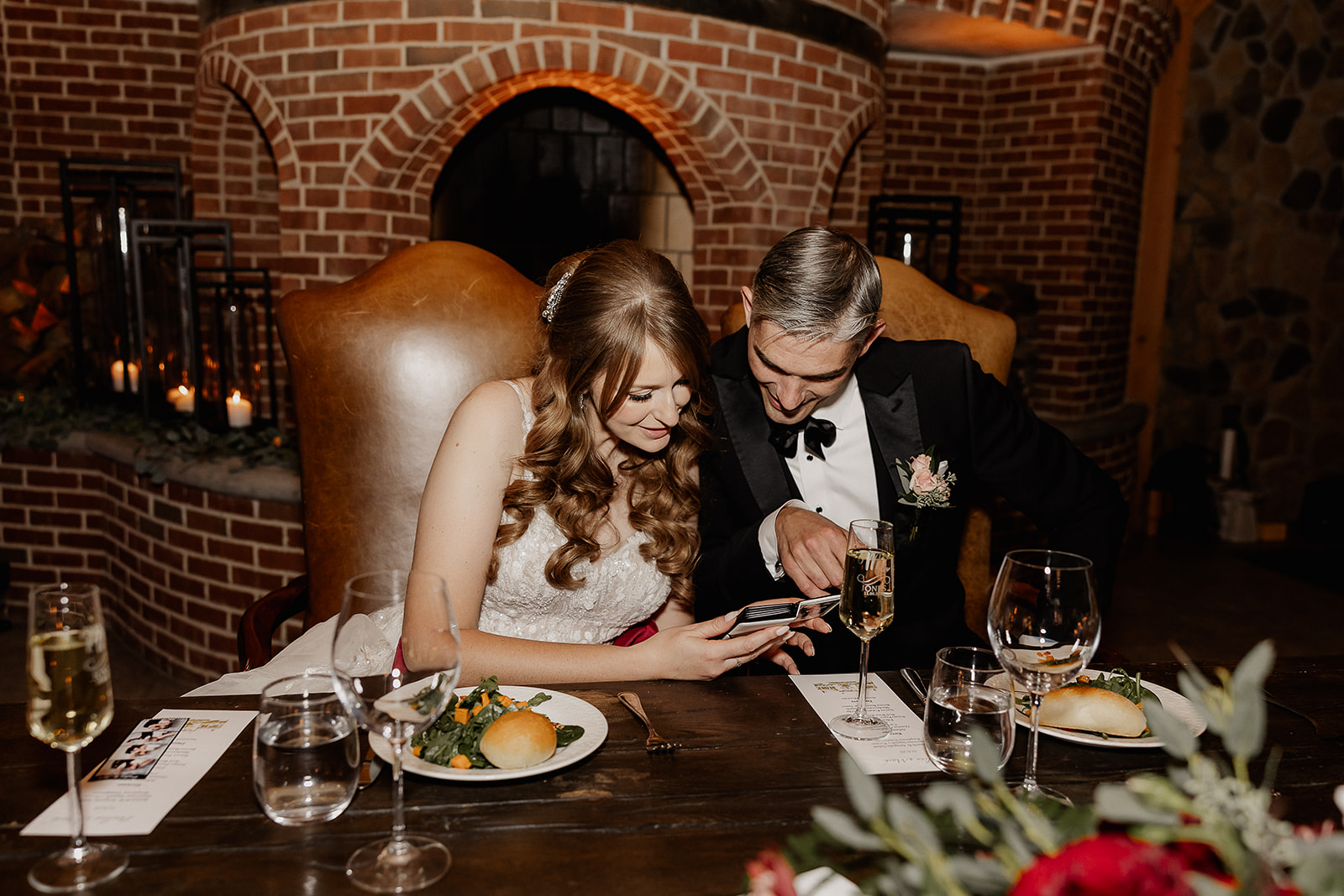 Bride and groom admiring their little book of polaroid photos from their wedding.
