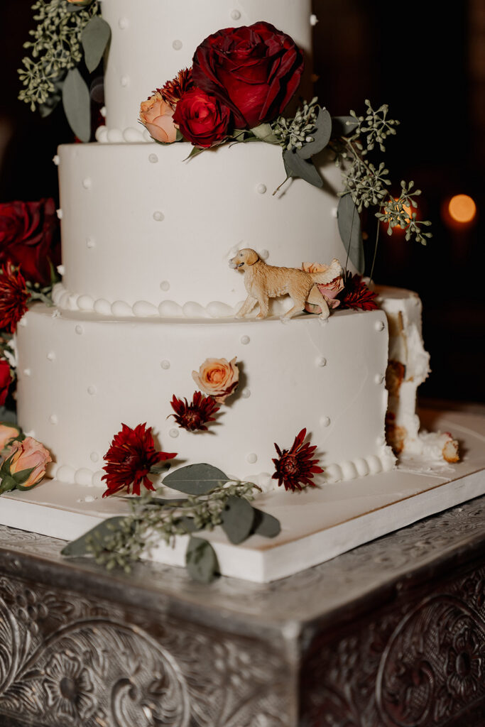 Close up shot of a cut into three tiered wedding cake.