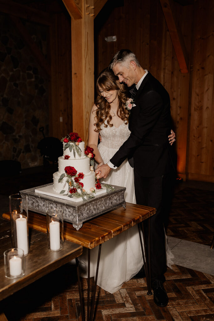 Bride and groom cutting into their wedding cake.