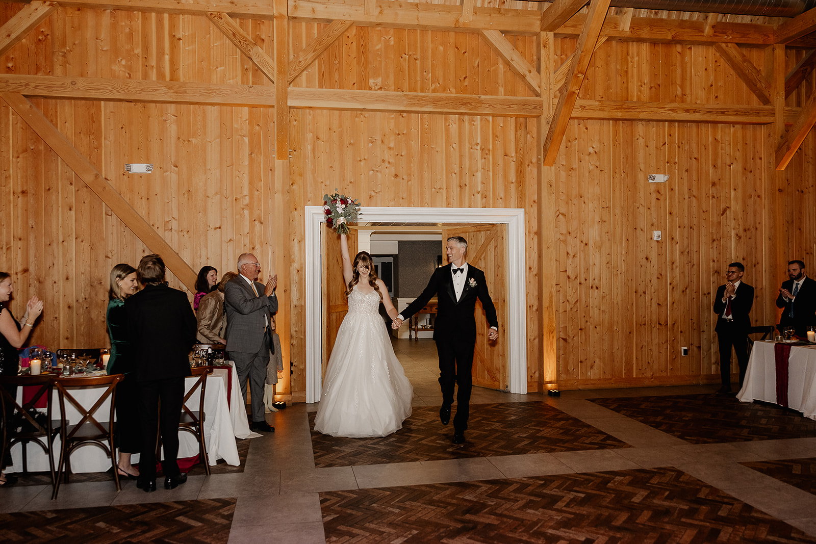 Bride and groom entering their wedding reception at The Farmhouse wedding venue in Hampton, NJ.