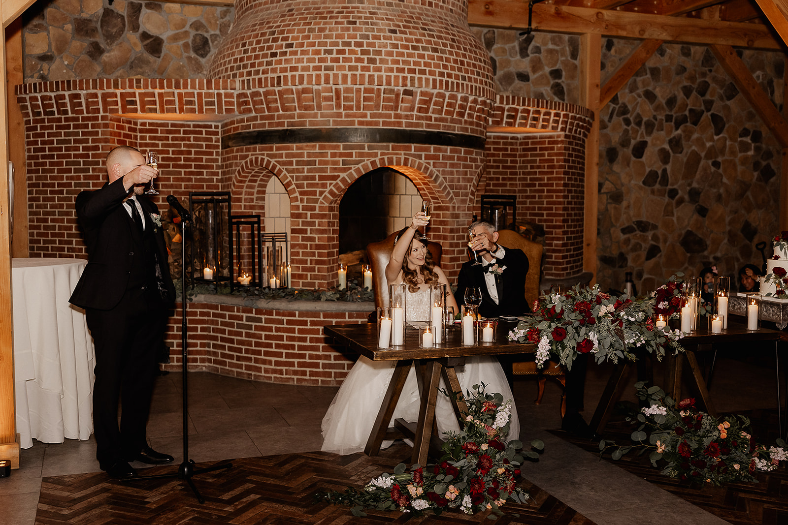 Bride and groom toasting during wedding reception speeches.