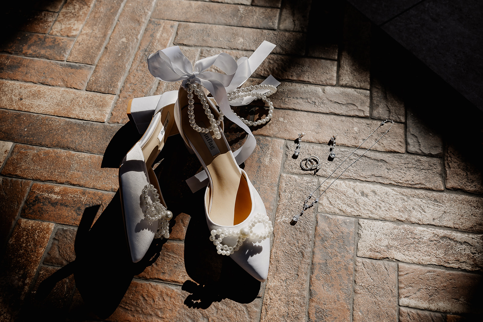 Detail shot of the brides heels and wedding jewelry.