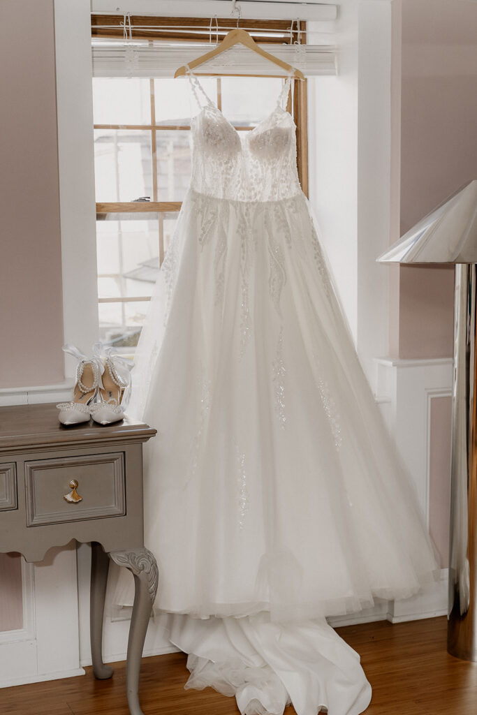 Brides wedding dress hanging at The Farmhouse wedding venue in Hampton, NJ.