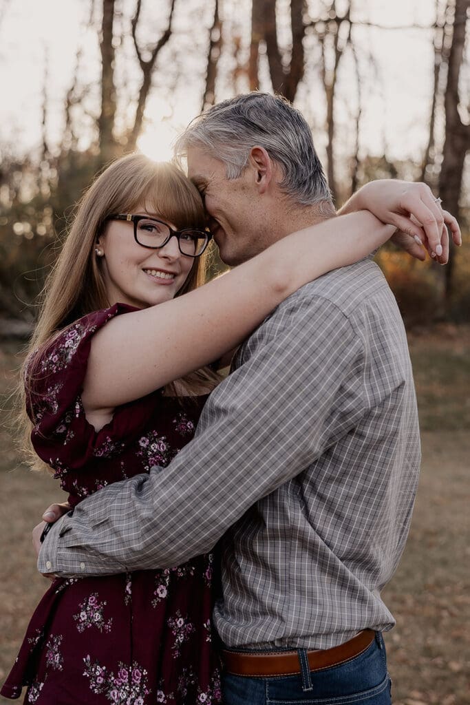 Couple posing for their engagement photos during golden hour at Jockey Hollow in Morristown, NJ.