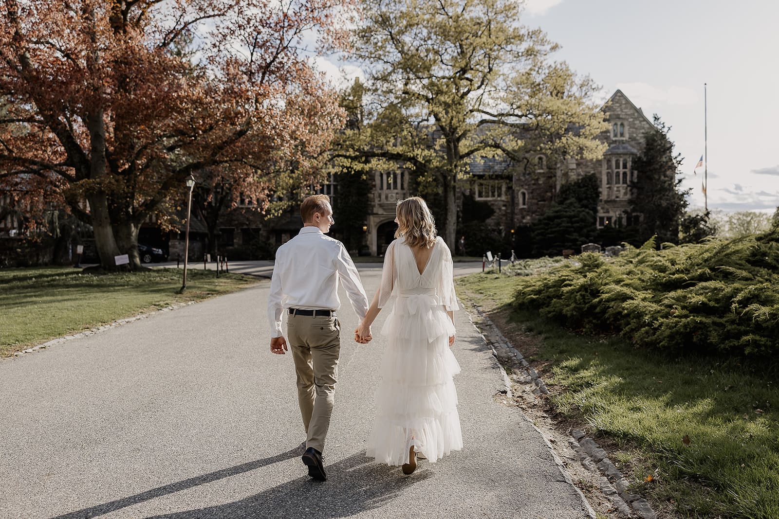 Couple holding hands and walking towards Ringwood Botanical Gardens in New Jersey.