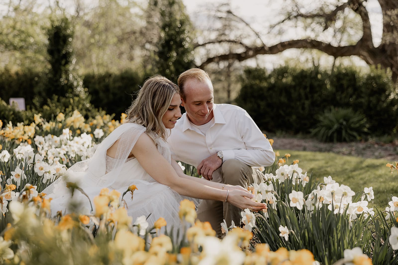 Couple admiring the flowers during their Ringwood Botanical Gardens Engagement Photos in New Jersey.