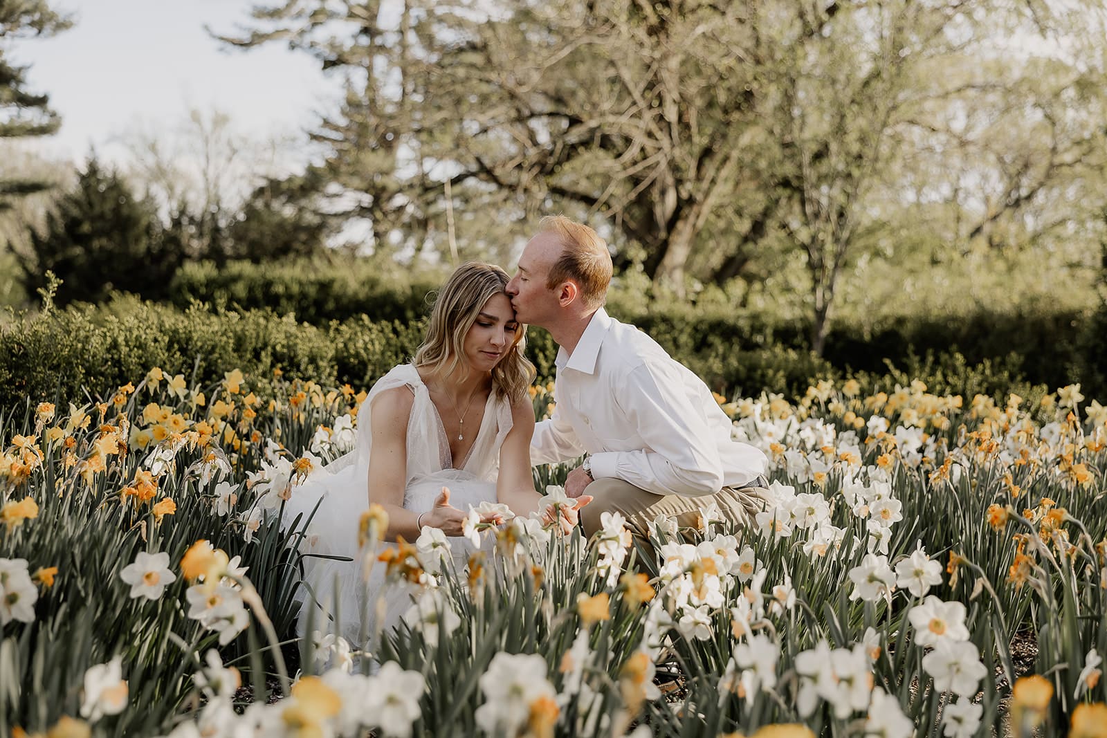 Couple sitting in wildflowers at Ringwood Botanical Gardens for their NJ engagement photos.