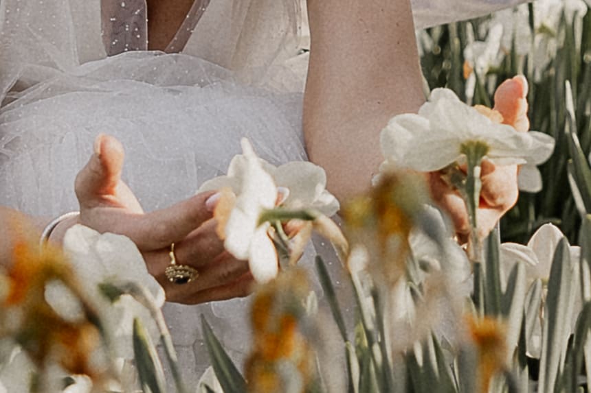 Engagement photo detail shot of a bride-to-be admiring flowers at Ringwood Botanical Gardens.