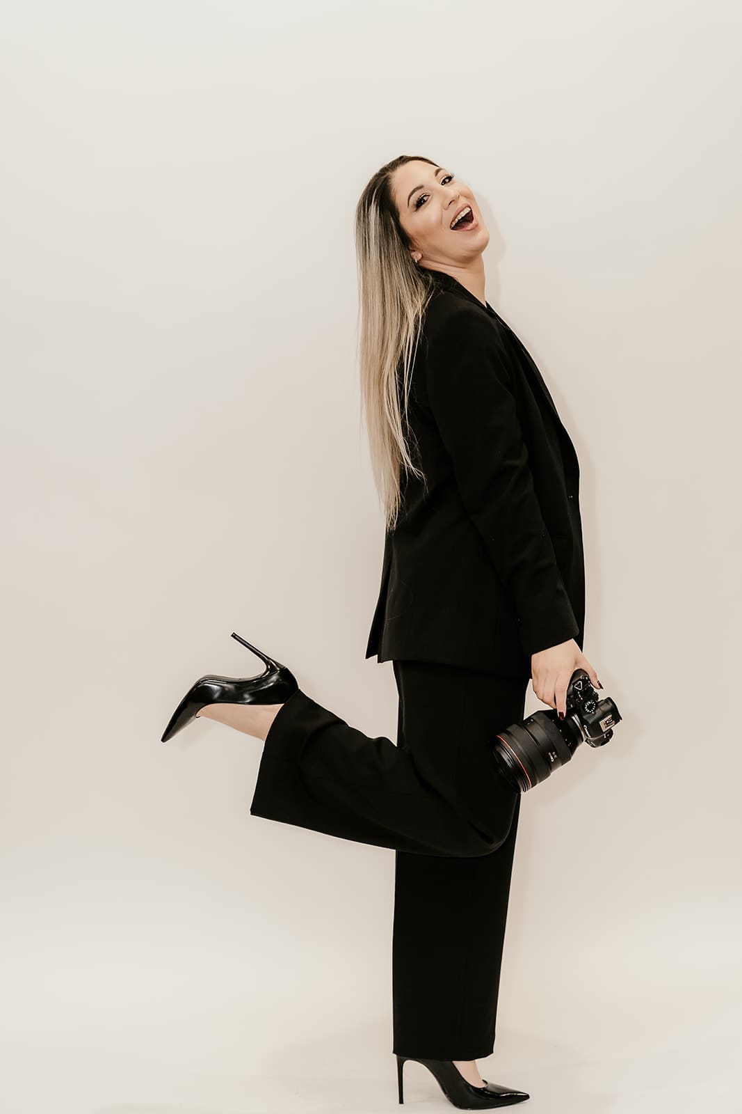 Sari Photography - NJ engagement photographer holding he camera and posing for a portrait. 