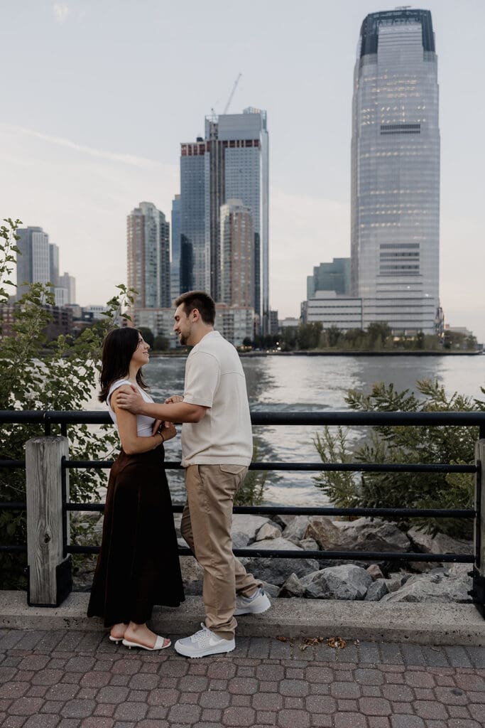 Couple posing for their NJ engagement photos at Liberty State Park in Jersey City.