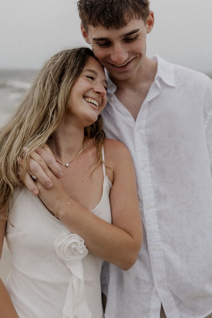 Close up photo of a couple smiling during their photo session.