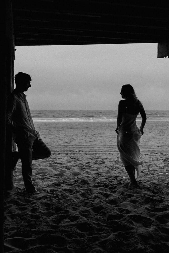 Black and white photo of a couple posing for their Long Branch Beach engagement photos in NJ.