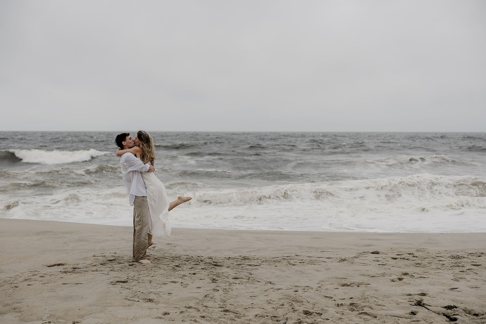 Man picking up his fiancé near the beach in Long Branch, NJ for their engagement photos.