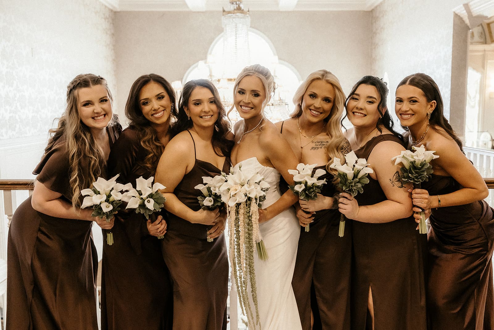 Bride smiling with bridesmaids during wedding party photos at The Brownstone in Paterson, NJ.