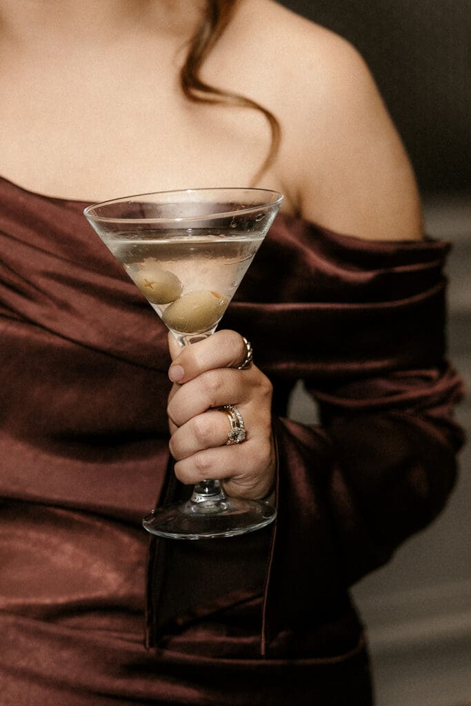 Guest holding a martini during cocktail hour.