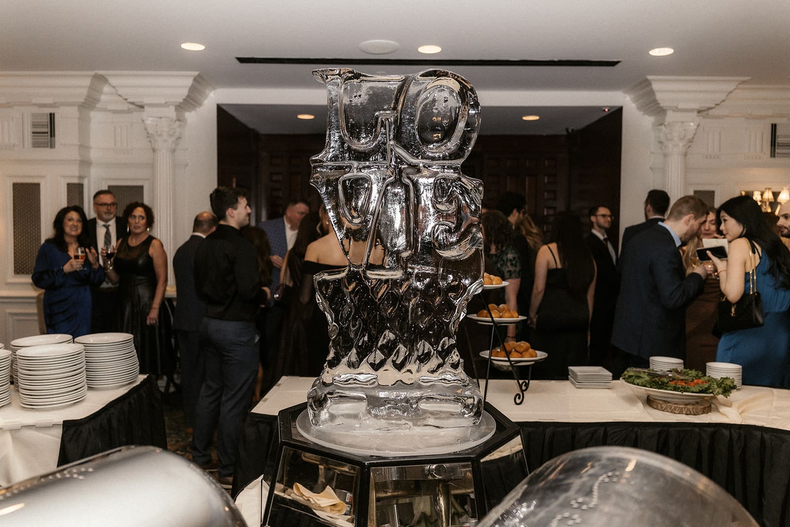 Ice sculpture from cocktail hour that spells love. 