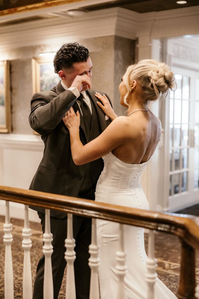 Groom wiping away tears after seeing his bride for the first time at The Brownstone in Paterson, NJ.