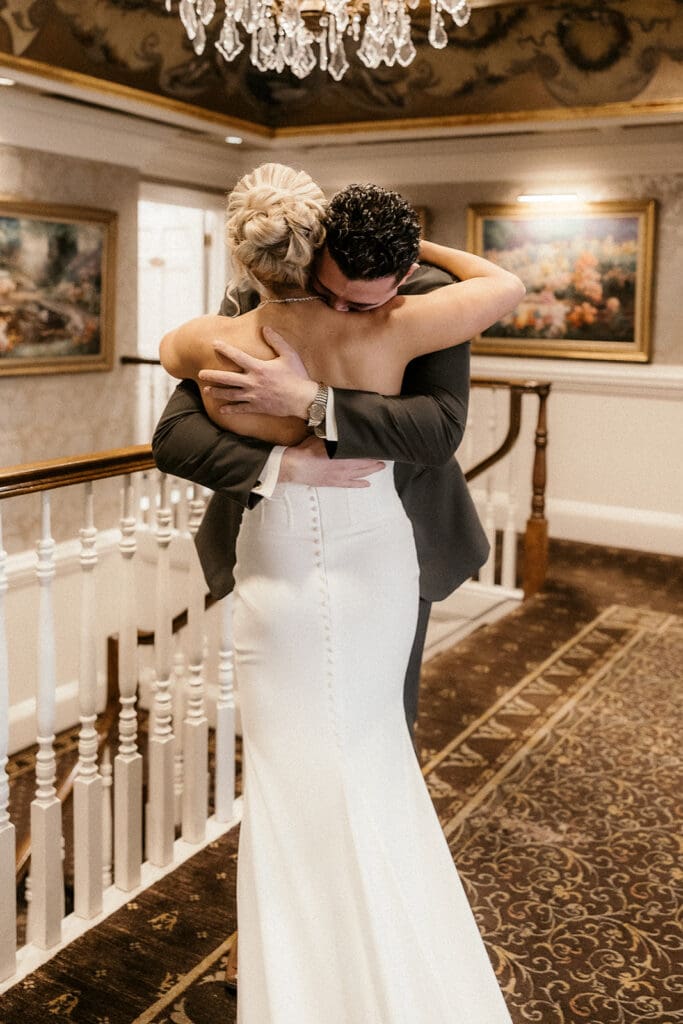 Groom hugging the bride emotionally after seeing her during their first look at The Brownstone in Paterson, NJ.