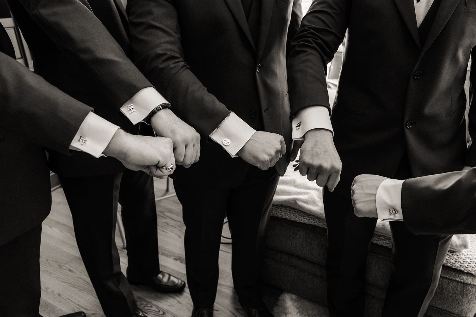 Groom and groomsmen showing their custom matching cufflinks. 