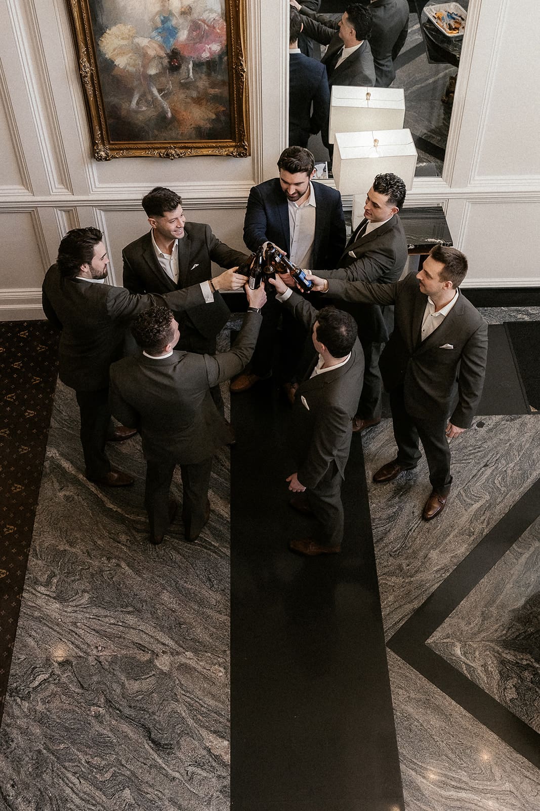 Groom and groomsmen toasting with beers before the ceremony.
