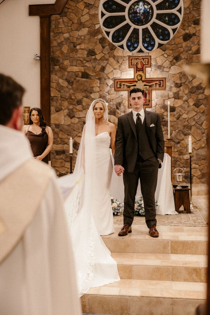 Bride and groom standing together during their Catholic wedding ceremony at St. Mary’s Church in Pompton Lakes, NJ.