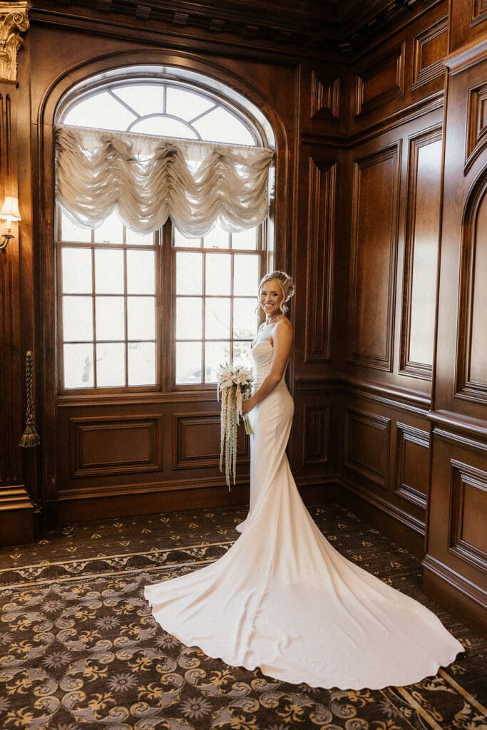 Indoor bridal portraits by a window at The Brownstone in Paterson, NJ.