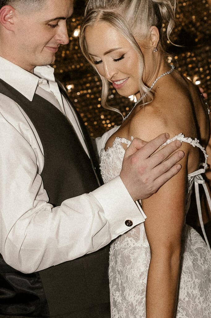 Bride and groom posing together after an outfit change at The Brownstone in Paterson, NJ.