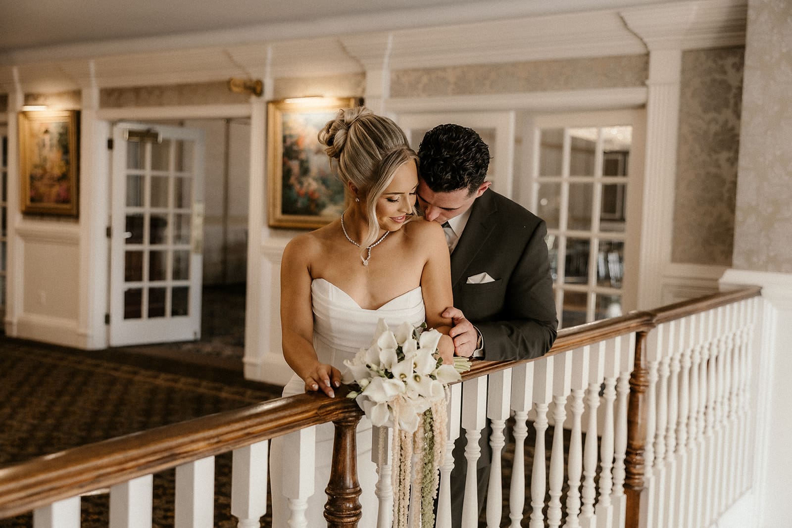 Bride and groom posing together on the balcony inside The Brownstone in Paterson, NJ.