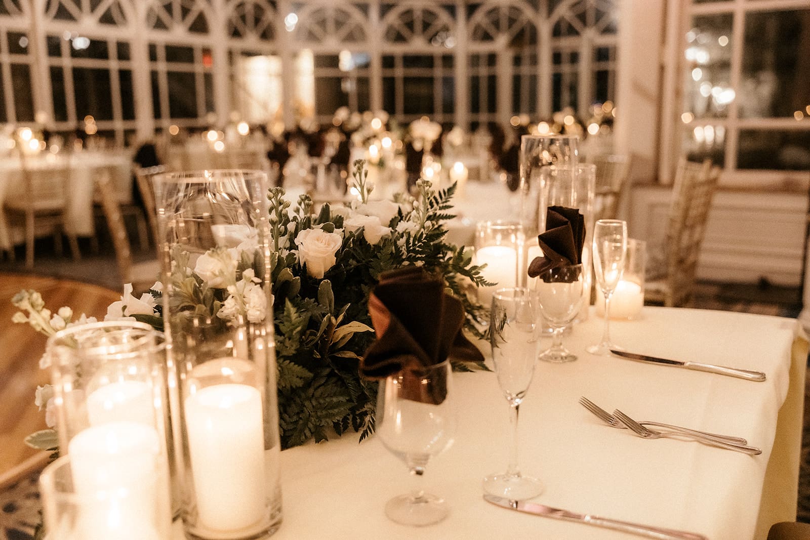 Candlelit reception table with white flowers at The Brownstone in Paterson, NJ.