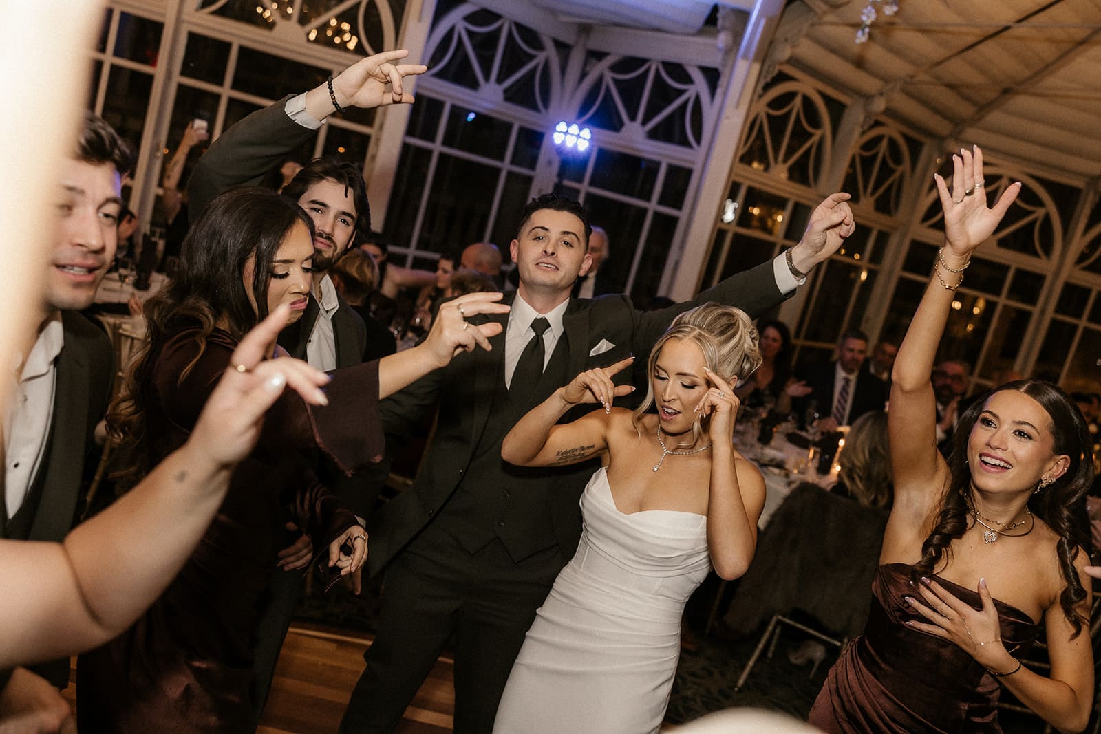 Bride, groom, and wedding party dancing during a reception at The Brownstone in Paterson, NJ.