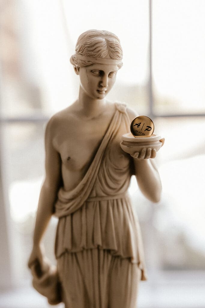 Custom cufflink that says A | P styled on a statue at Brides dress hanging on the wall at The Brownstone in Paterson, NJ.