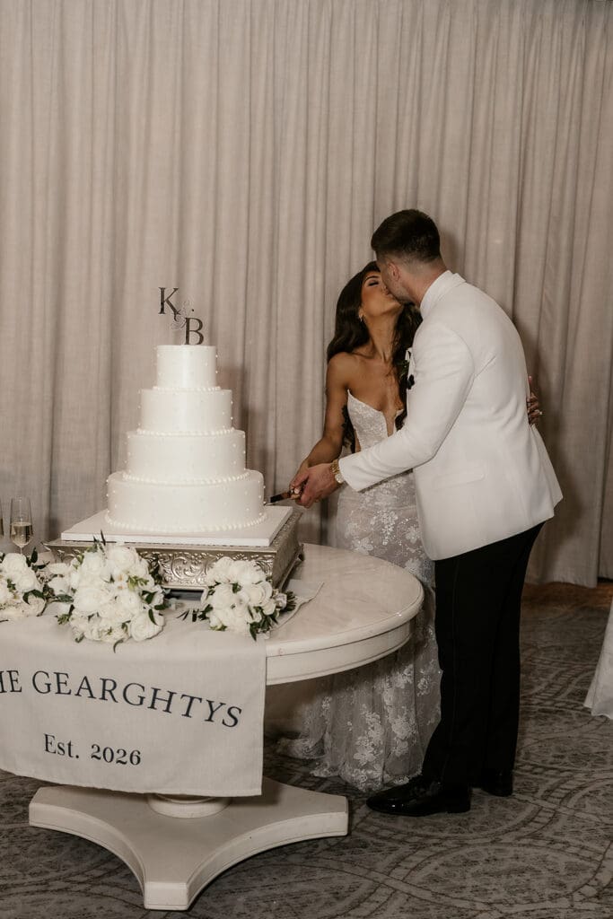 Bride and groom cutting into their wedding cake.