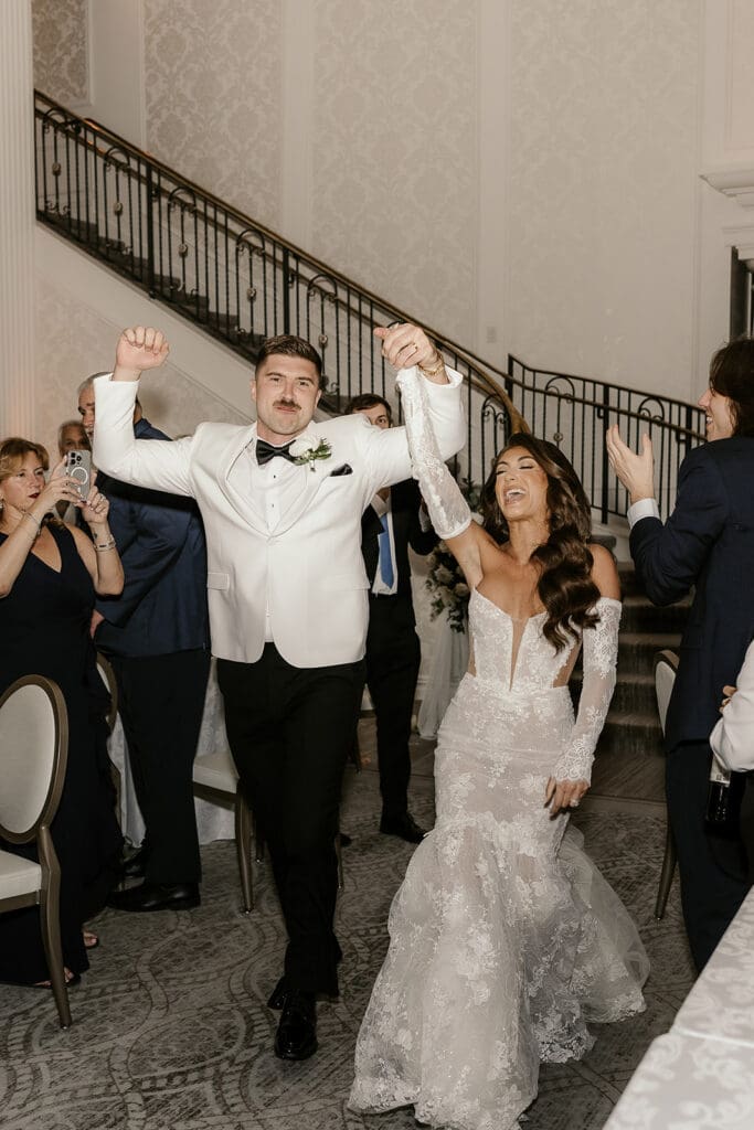 Bride and groom entering their wedding reception.