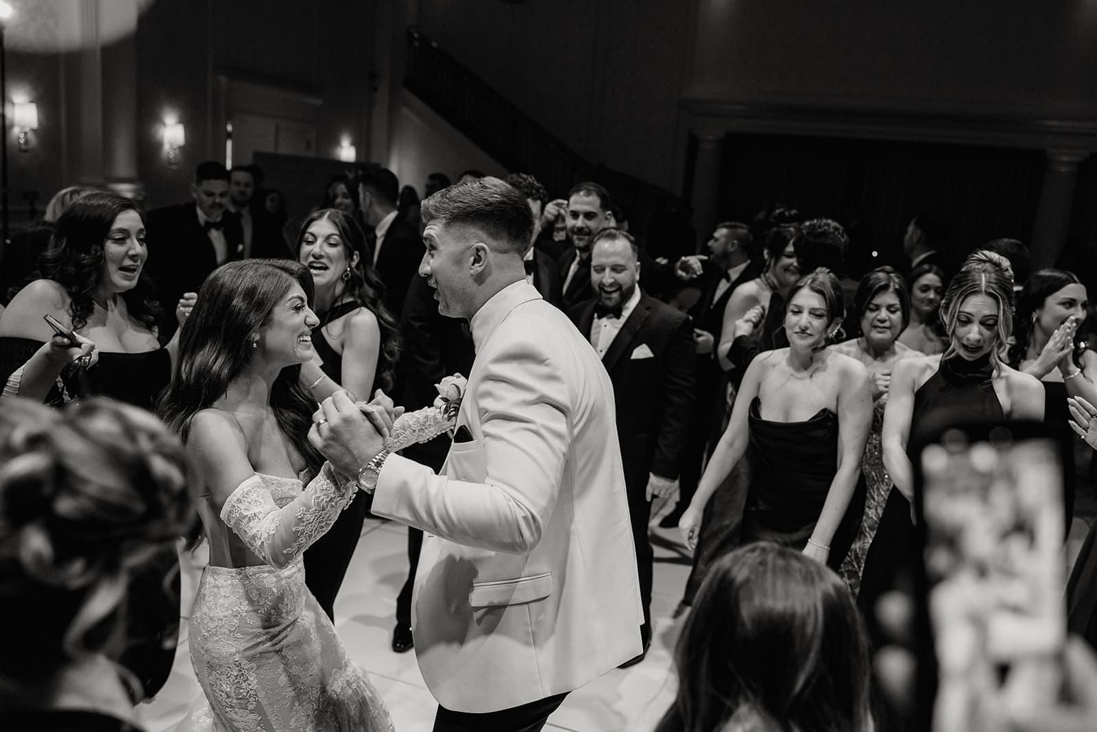 Black and white photo of a bride and groom dancing during their reception.