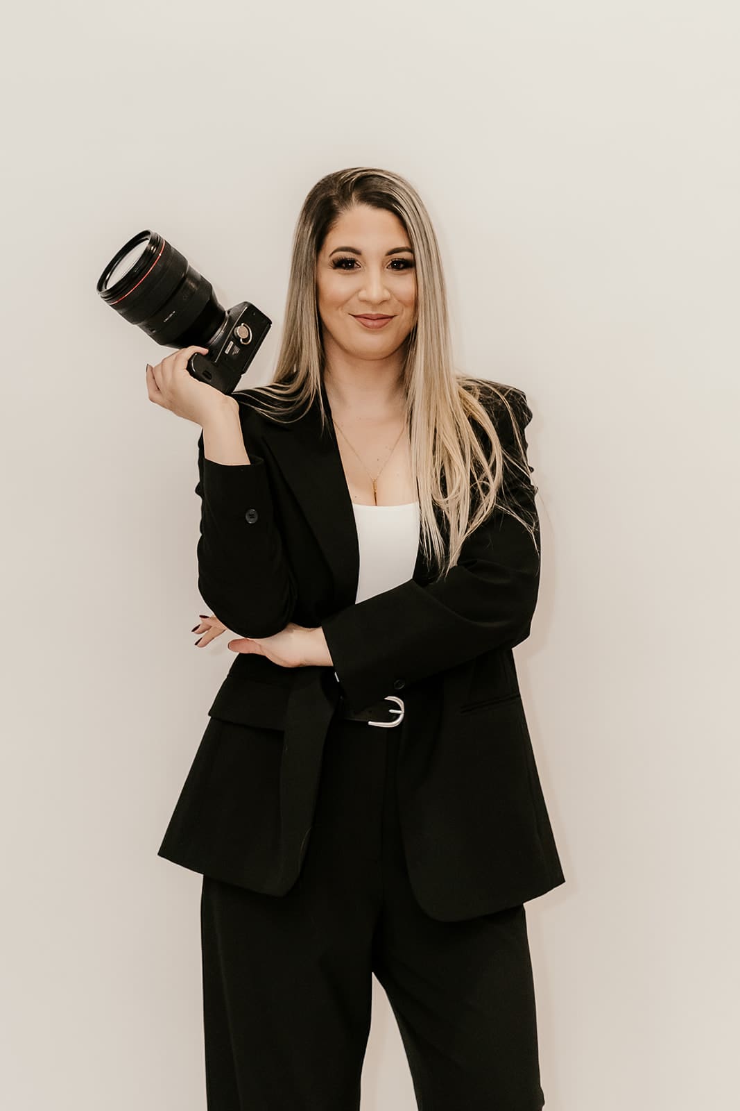 Sari, owner of Sari Photography holding her camera for her branding photos.